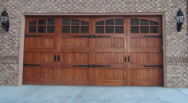 Double carriage house style garage door on garage with brick siding