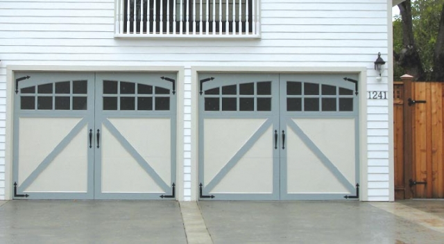 Two carriage house garage doors with dual color finish and dark decorative hardware