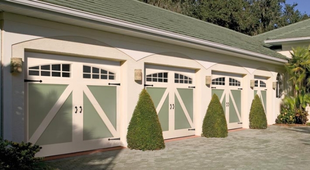 Four-car garage with custom painted carriage house style garage doors