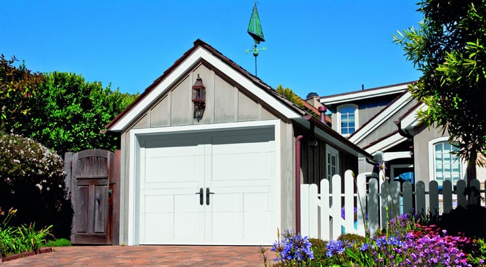 Photo of single car garage with simple carriage house garage door in gray