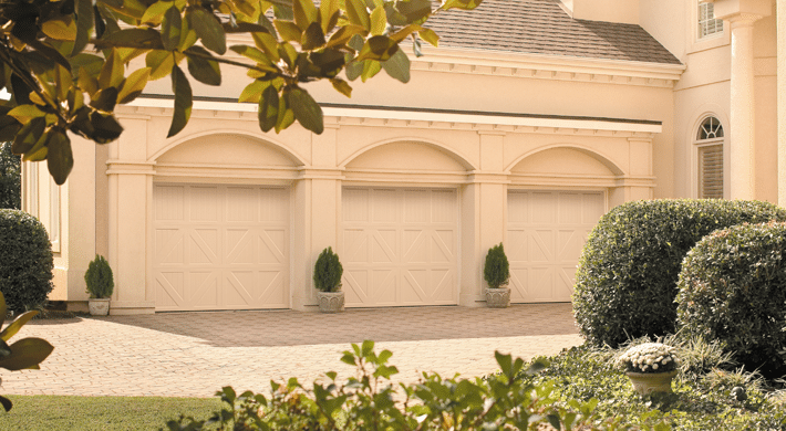 Photo of three car-garage with three individual garage door openings, valencia style carriage house garage doors