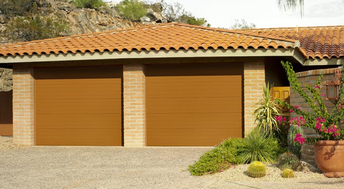 two car garage with tile roofing and two brown amarr heritage garage doors