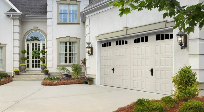 Almond carriage house style garage door on attached garage
