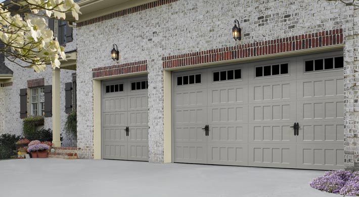 Sandtone carriage house style garage doors on attached two car garage