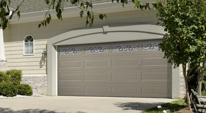 two car garage with wide panel garage door with windows along the top