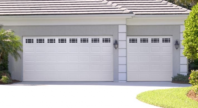 Three car garage with two white garage doors