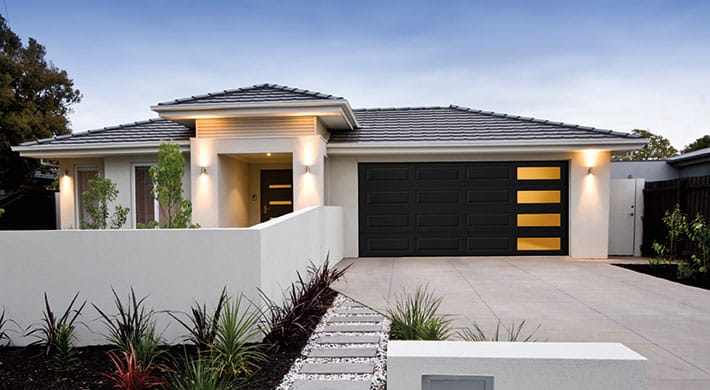 Modern house with white stucco and black mosaic garage door
