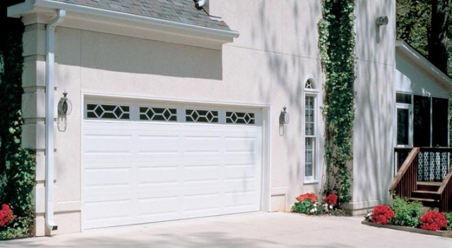 Two car garage door with white door and diamond windows