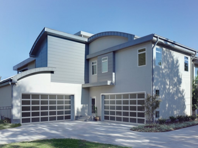 Multi-story house with two modern garage doors