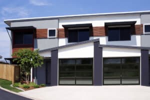 modern house with two specialty garage doors with glass panels
