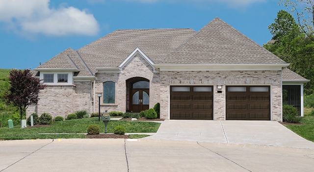 Suburban brick house with two car garage and elegant entrance door