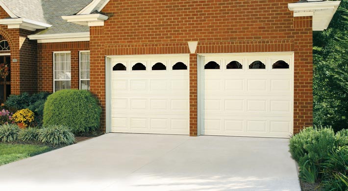 two car garage with two short panel amarr stratford garage doors in white with windows