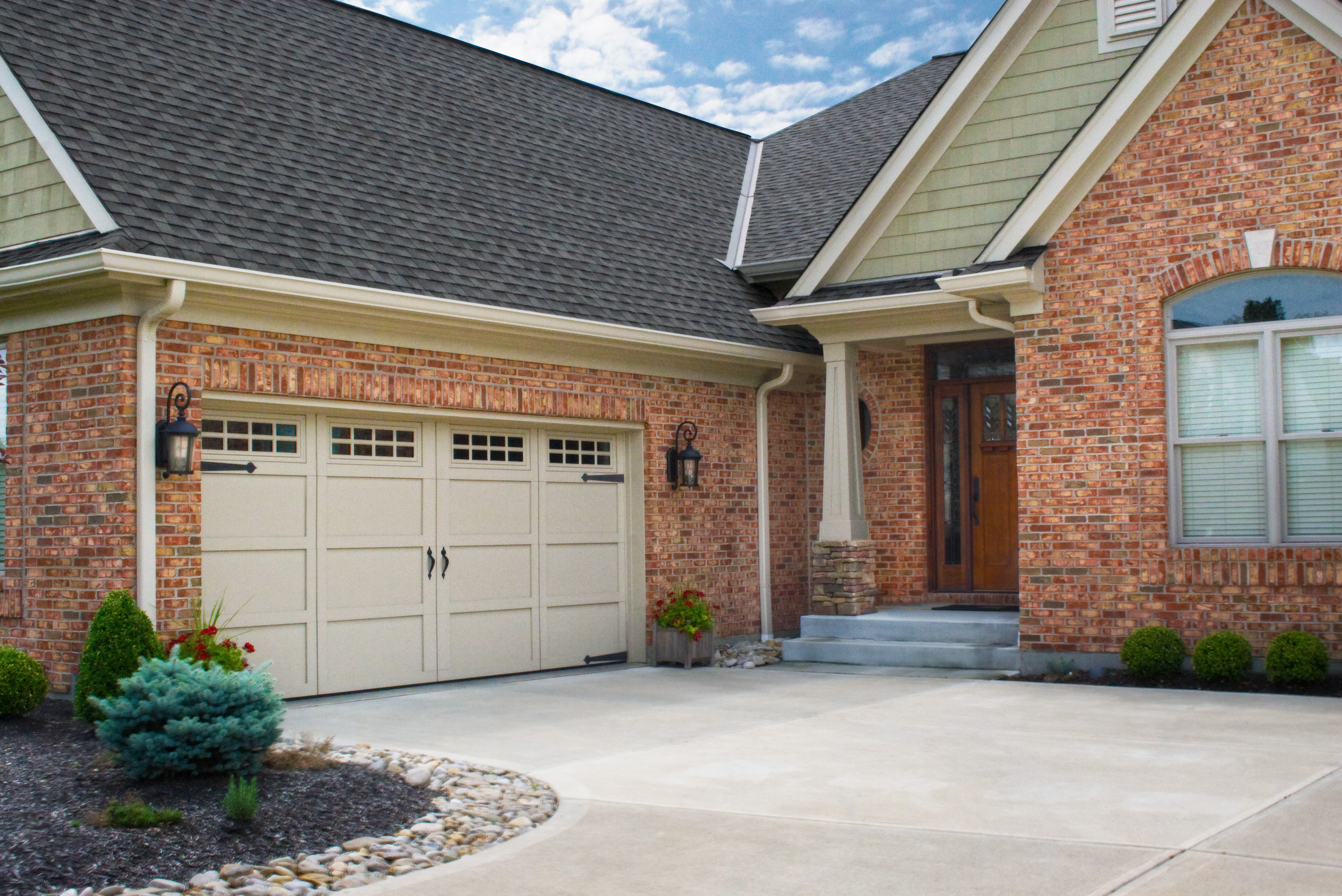 tan garage door with red brick