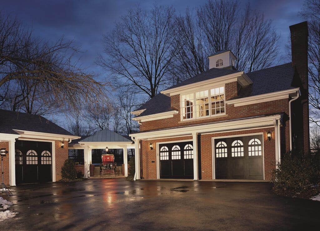 colonial home with black one car garage doors