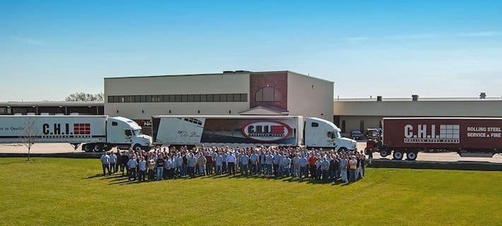 CHI employees and trucks in front of CHI headquarters office. Image for Amarr vs CHI garage doors comparison.