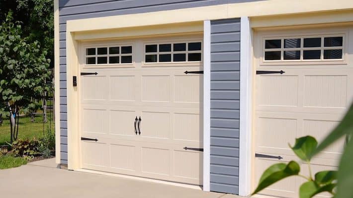 Close-up of CHI garage doors with windows in top panel. Image for Amarr vs CHI garage doors comparison.