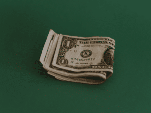 folded dollars on a green background