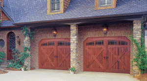Two red wood garage doors with glass lites. 