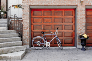 Bike leaning against a wood garage door. 